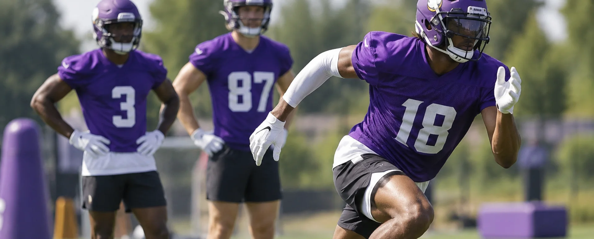 Vikings receivers running route drills on the practice field in Eagan